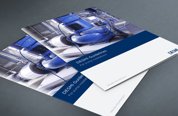 Two DESMI brochures featuring fluid handling equipment on a gray surface.