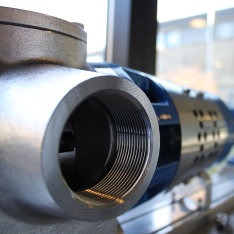 Close-up of a DESMI industrial pump for fluid handling in a workshop.