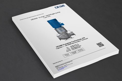 DESMI in-line centrifugal pump Type DSL manual on a dark surface.
